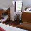 The image is well-lit and sharp, with good color accuracy and a photo-realistic appearance. Key elements like the bunk beds and the chair are in focus. The composition is decent but could be improved, as the angle feels slightly off-center, and there's minor overexposure around the window area.